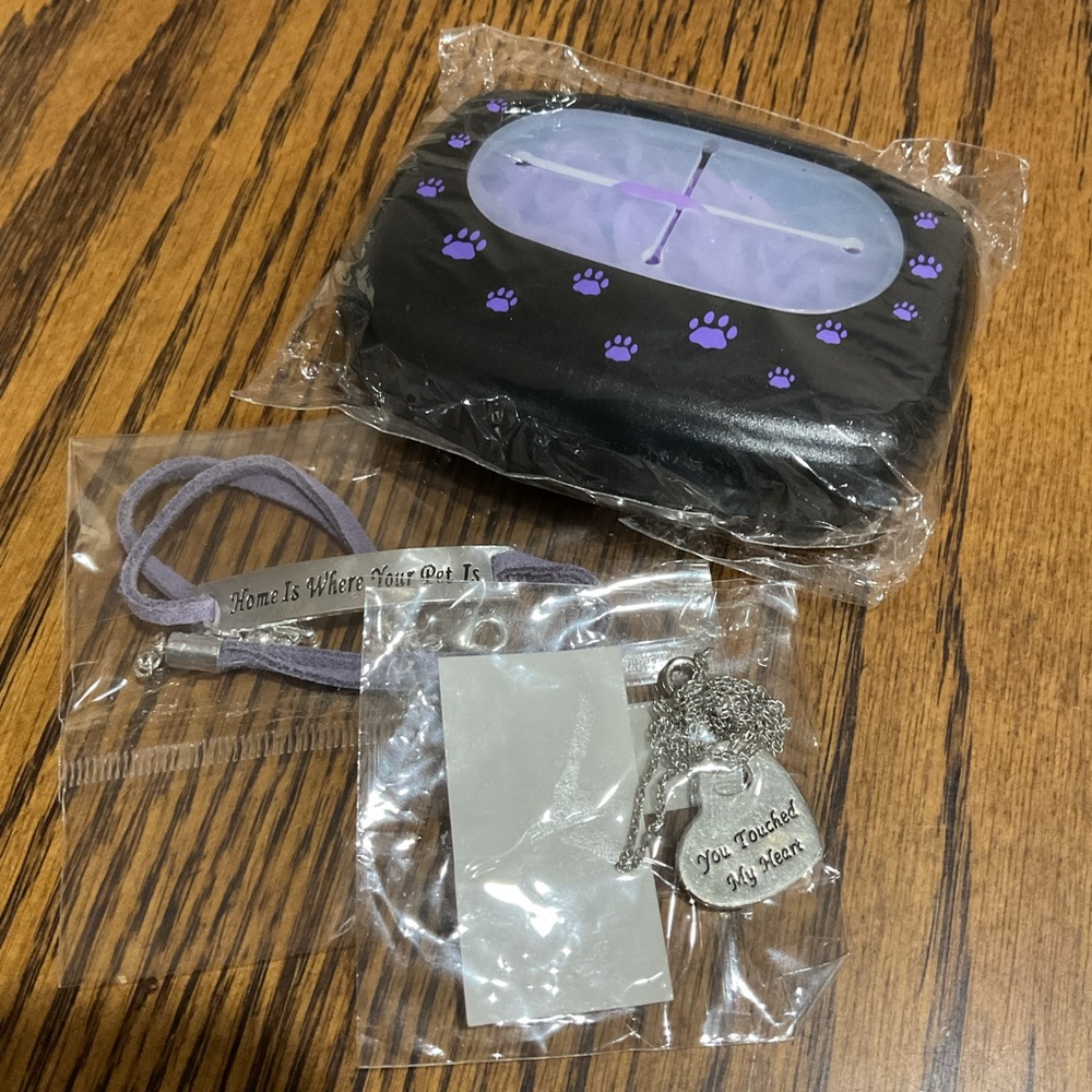 Bracelet with paw charm, heart necklace & container with purple rubber bands